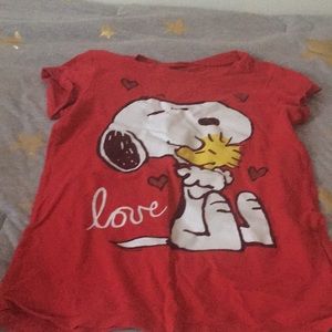 this red shirt with snoopy on it .